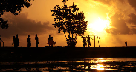 young people playing soccer on the beach (Sunset), french polynesia