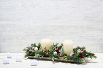 Festive composition of Christmas decorations on white wooden background.