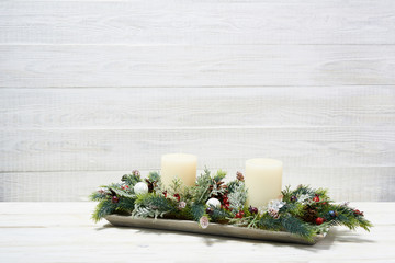 Festive composition of Christmas decorations on white wooden background.