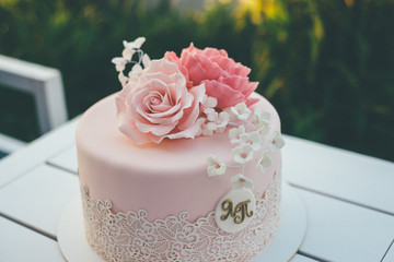 Glazed pink wedding cake on the table