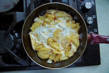 Freid potatoes . Potato fries with egg. Potato fry in the pan with a shellfish.