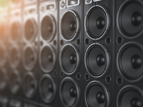 Audio  sound speaker system. Black loudspeakers in a row with DOF effect. Music club background.