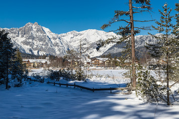 Seefeld lake in Tyrol on a sunny winter day with view to the village