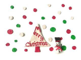 Cute snowman have sweet smile, colorful spiral snow and red Merry Christmas tree made from plasticine clay are placed on white background, beautiful dough decorate are festival