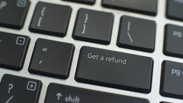 Get a refund button on computer keyboard, female hand fingers press key