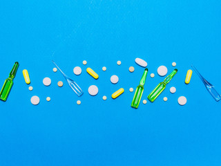pharmaceutical medical blue background. Top view of the pills, ampoules, pills. Place for text