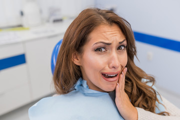 Close up of female patient with toothache in dental clinic