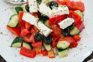 Salad with mozzarella cheese, olives, tomato and cucumber