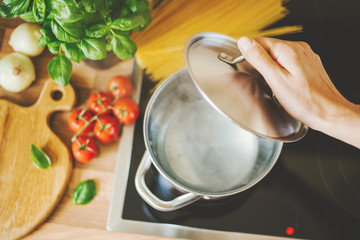 Man cooking pasta in boiling water