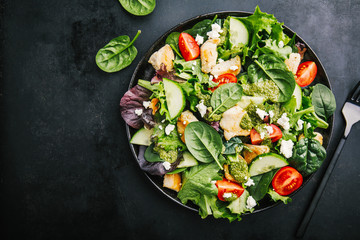 Tasty fresh salad with chicken, pesto and vegetables