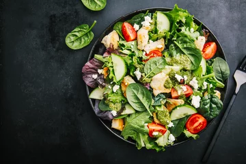 Gordijnen Tasty fresh salad with chicken, pesto and vegetables © nerudol