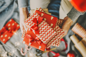Man making bow from ribbon on gift