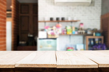 Selected focus empty brown wooden table and Coffee shop or restaurent blur background with bokeh image. for your photomontage or product display.