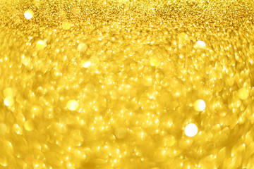 Christmas card with copy space, gold bokeh, sparkles, defocused lights. Festive abstract texture. Glittering background.