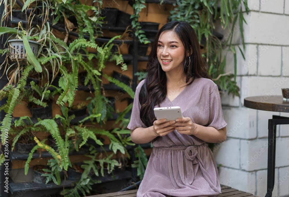 Sticker happy woman using credit card to shopping online with tablet at cafe