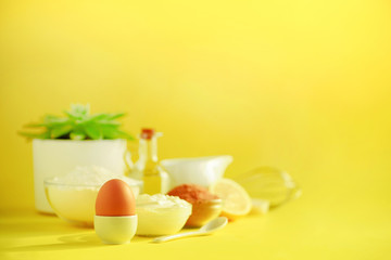 Healthy baking ingredients - butter, sugar, flour, eggs, oil, spoon, brush, whisk, milk over yellow background. Banner. Bakery food frame, cooking concept with succulent plant. Copy space.