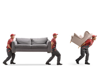 Movers carrying a couch and an armchair