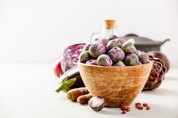 Purple Brussels sprouts in a wooden bowl