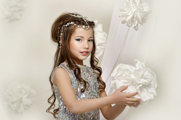 Little girl in a silver dress. Caucasian, attractive.