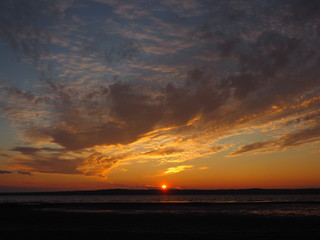 Sunset. On the big river. Coast. Beautiful clouds. Summer. Russia, Ural, Perm region