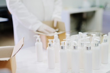 Picture of lotion bottles on production line. Bottles of cosmetic products in factory production...