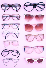 Group of vintage  man and woman spectacles isolated on pink background