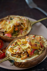 Autumn food with fresh vegetables, quick lunch: eggplant stuffed with tomatoes and cheese. The concept of healthy and vegetarian food.