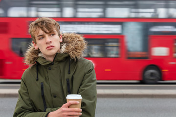 Male Young Adult Teen Drinking Coffee By Red London Bus © Darren Baker