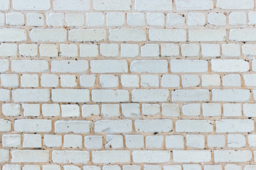 old cracked white brick wall in hoarfrost