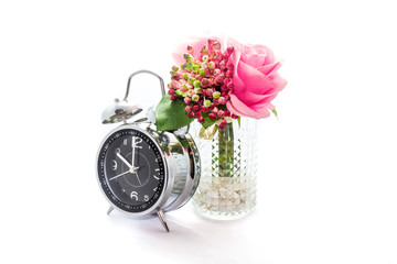 Artificial plastic flowers with clock isolated on white background.