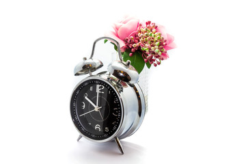 Clock and Artificial plastic flowers isolated on white background.