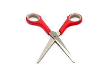 Scissor with red plastic handles isolated on white background.