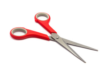 Scissor with red plastic handles isolated on white background.