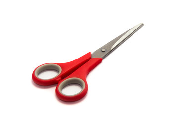 Scissor with red plastic handles isolated on white background.