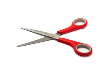 Scissor with red plastic handles isolated on white background.