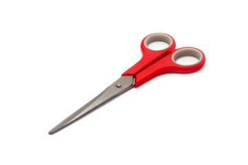 Scissor with red plastic handles isolated on white background.