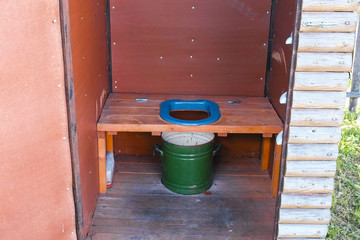 Outside toilet with a pot in village.