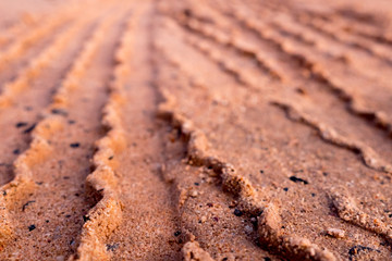 Tire mark on brown soil and sand