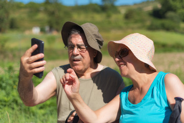 Senior couple on hike taking a selfie