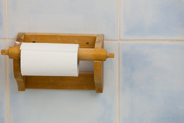 Wooden toilet paper container in bathroom