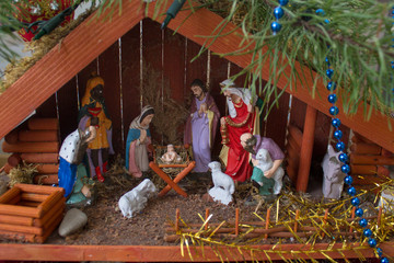 house Christmas Nativity,the birth of Jesus in the manger between the animals in a wooden house