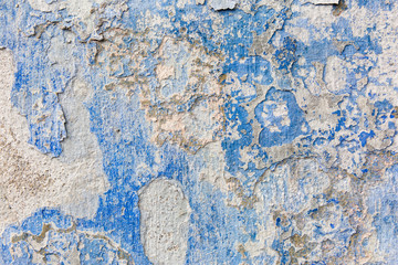 Old weathered blue plaster wall texture. Grunge background.