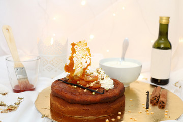 Dried apricot cake with mascarpone frosting and grape syrup, decorated for Christmas. Selective focus.
