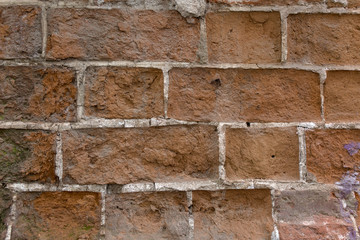 Grunge brick texture. Close up old wall peeling plaster.