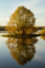 Soft autumn landscape, reflected in calm water