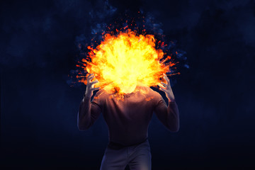 A dark shape of an angry man with an exploding head on a black background.