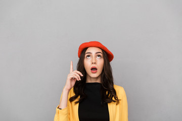 Close up of a shocked young woman in red hat