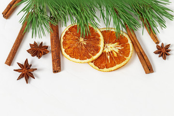 Obraz na płótnie Canvas Dry orange fruit. Dried oranges slices, cinnamon sticks, anise star on light background. Spices for hot wine. Background for new year.
