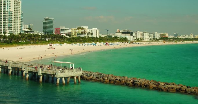 Low aerial Miami Beach fishing pier
