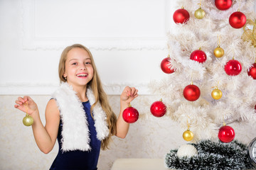 Family holiday concept. Girl velvet dress feel festive near christmas tree. Very special time of...